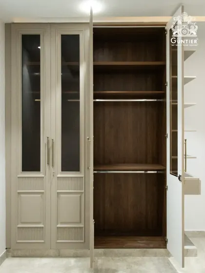 A glimpse inside the classic wardrobe design, showing the rich, dark wood interior that contrasts beautifully with the lighter exterior.