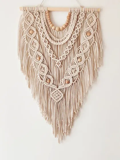 This 18-inch wide wall hanging is a perfect medium-sized statement piece, full of texture and bohemian charm.
