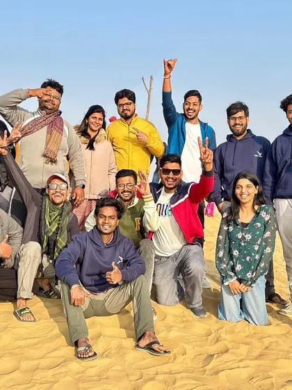A fun group picture on the sand dunes. The joy and camaraderie in this photo capture the essence of our group trips.