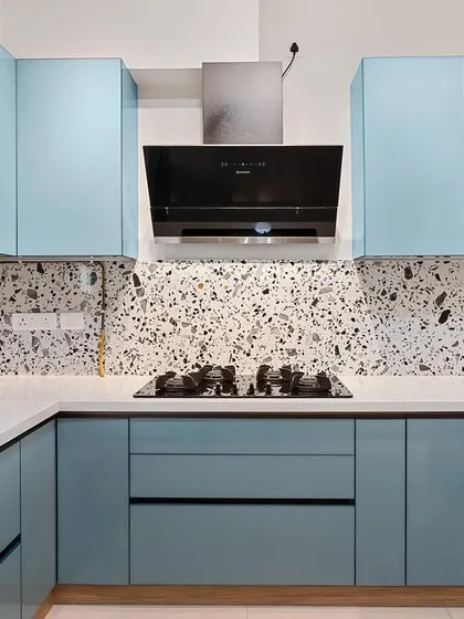 This kitchen features a beautiful combination of powder blue cabinets and a terrazzo-style backsplash. It’s a great example of how to use color and pattern to create a kitchen with personality.