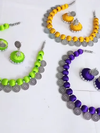 When a customer wanted Holi colors, we created these custom silk thread necklace sets. This image shows them in vibrant neon green, turmeric yellow, and deep purple.