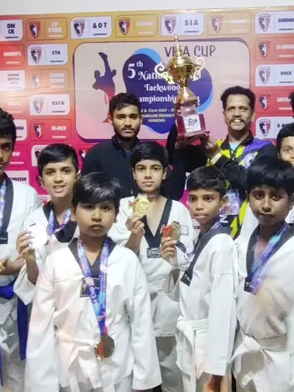 Our athletes posing with their medals and the winners' trophy after the 5th National Level Taekwondo Championship organized by TEAM VIFA. A great performance by the entire team.