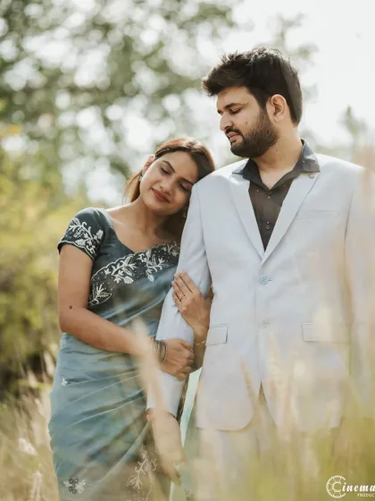 A tender moment where she rests her head on his shoulder. This classic pose, combined with the soft natural light, results in a timeless and romantic portrait.