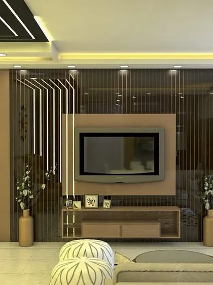 A warm and inviting living room with an elaborate TV wall unit featuring vertical slats and integrated lighting. The neutral-toned furniture creates a comfortable and elegant space for relaxation.