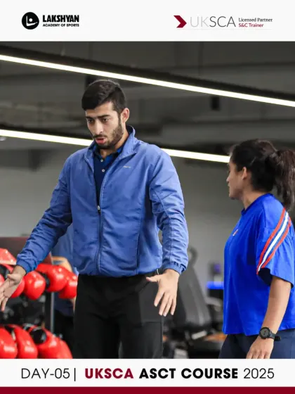 Participants engage in a peer coaching session on Day 5, discussing cues and techniques for various exercises in preparation for their final assessments.