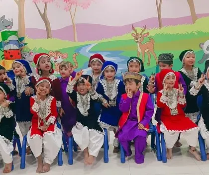 Another view of the happy performers in their Kashmiri costumes, highlighting the comfortable fit that allows them to enjoy their special day.