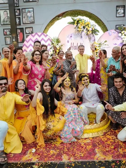 A happy group photo from a rooftop Haldi ceremony in Mumbai. I plan events that are all about bringing family and friends together for joyous moments like these.