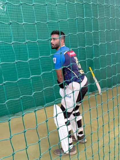 A batsman stands ready at the crease during a net session, focused and prepared to face the next delivery.