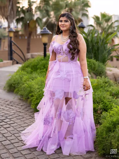 A full length shot of her gorgeous lavender gown. She looks like a princess.