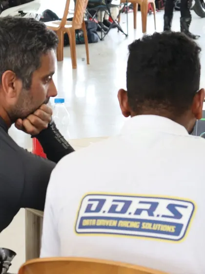 Another shot of me analyzing track data with a telemetry expert. We are always looking for new ways to help our students unlock their potential.