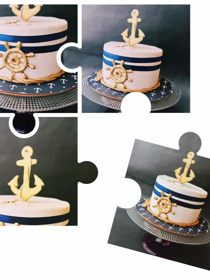 A charming nautical-themed cake with a golden anchor and ship's wheel, ideal for a sailor-themed party or baby shower.