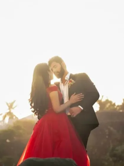 A golden hour pre-wedding portrait. The simple silhouette of our red gown is perfect for creating a timeless and romantic image against the sunset.