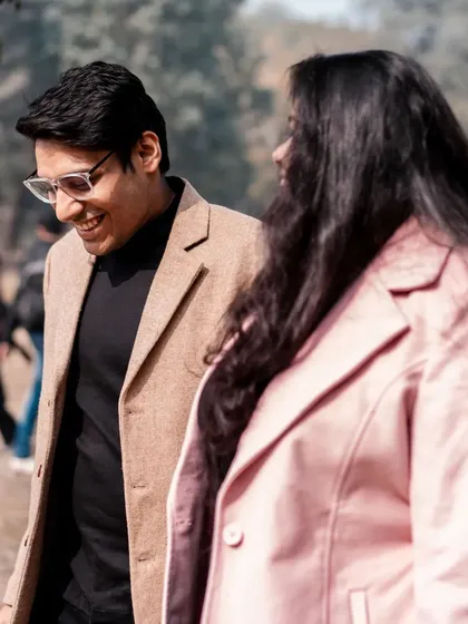 A casual stroll through the park, filled with smiles. This captures the simple, everyday happiness that is the foundation of a great love story.