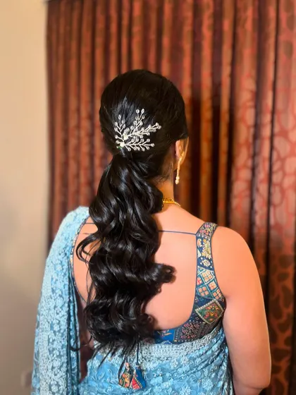 For receptions and modern events, a stylish high ponytail with soft waves is a great choice. It's chic, comfortable, and keeps the hair off your face while you celebrate.