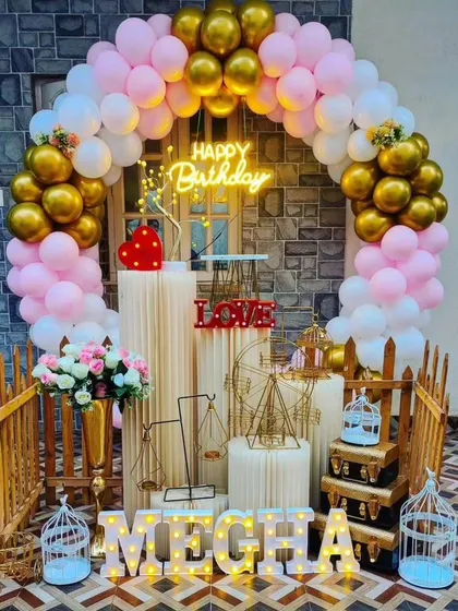 An outdoor birthday setup for 'Megha' in pink, white, and gold. This shows how our affordable packages can be adapted for different spaces.