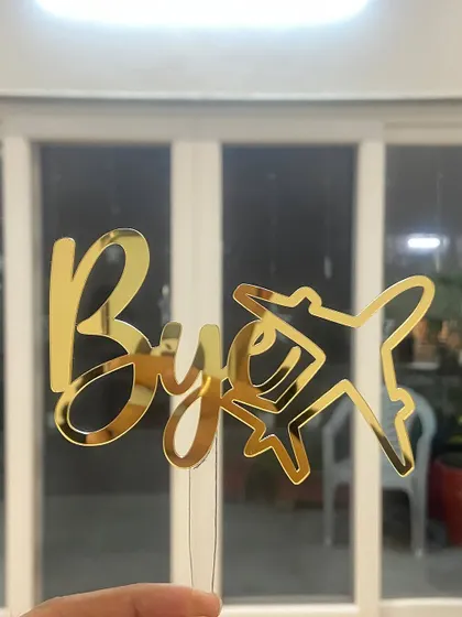 A fun "Bye Bye" topper with an airplane motif, perfect for a farewell party.