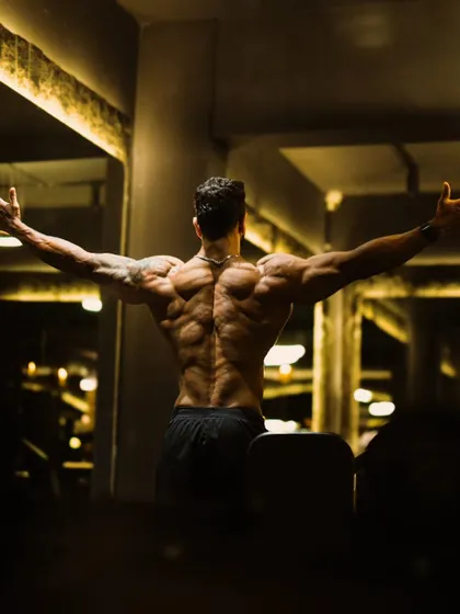 A powerful shot showcasing the intricate musculature of the back, a result of dedicated strength training and bodybuilding techniques.
