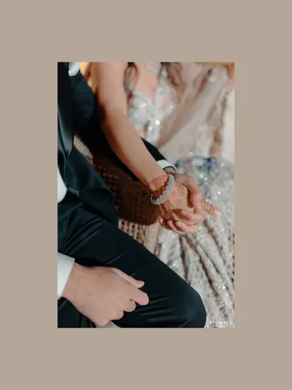 A close-up detail shot of the couple holding hands, a simple yet powerful symbol of their new beginning together.