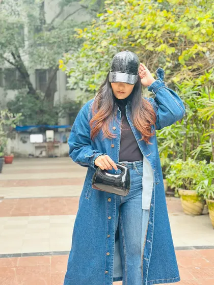 A stylish and practical winter look, the long denim jacket provides warmth without sacrificing style.