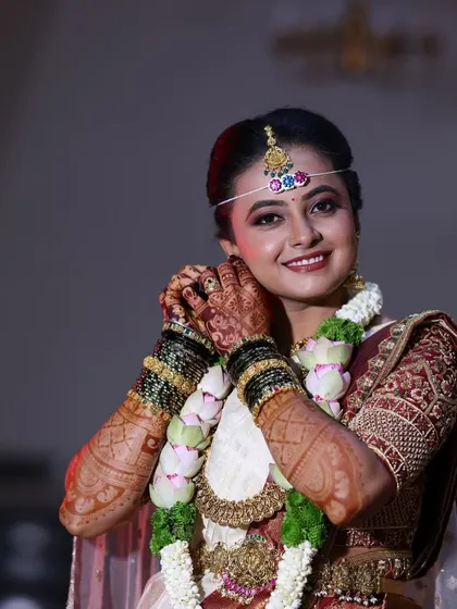 Another shot of the bride adjusting her earring, highlighting the beautiful henna stain.