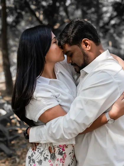 A heartfelt embrace with a forehead kiss, symbolizing care, protection, and deep affection.