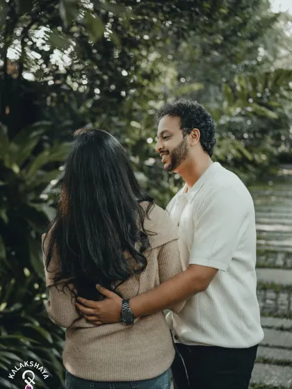 Capturing the look of love. This over-the-shoulder shot creates a personal and intimate perspective during a pre-wedding photoshoot.