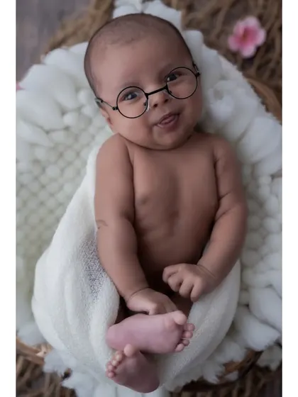 A touch of whimsy can create such a fun and memorable portrait. These tiny round glasses add a playful and studious charm to this little one's expressive face.