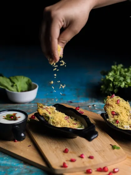Pure ingredients, pure joy. A beautifully plated chaat dish, garnished with sev and pomegranate seeds, showcasing the artistry in our food.