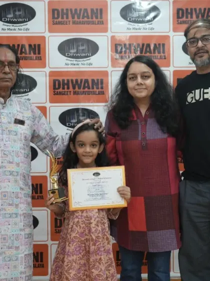 A student with her parents and guru, a happy family picture.