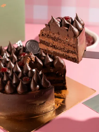 The perfect slice pull from a decadent chocolate cherry cake. Capturing the texture and layers is key to making desserts look as delicious as they taste.