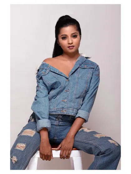 A bold and stylish portrait in a denim jacket. The pose is confident and the look is modern and edgy.