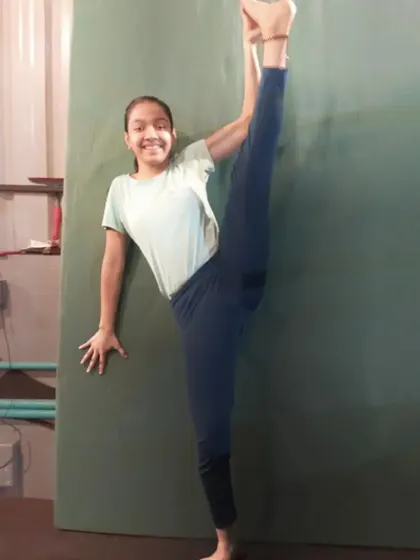 This student proudly shows off her standing split, a result of dedicated flexibility training. It's amazing to see how much progress they make with regular practice.