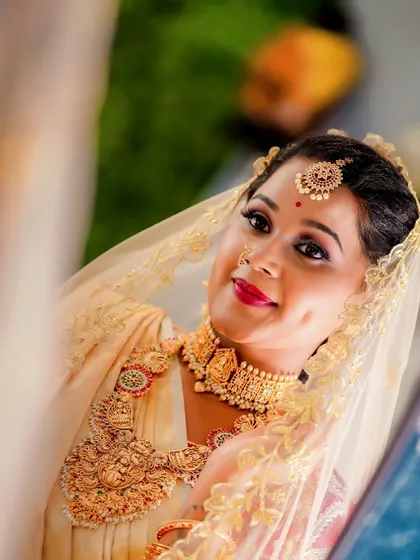 The beautiful dimple in her smile says it all. This bride's reflection shows a woman who is happy, confident, and ready to celebrate her wedding day.
