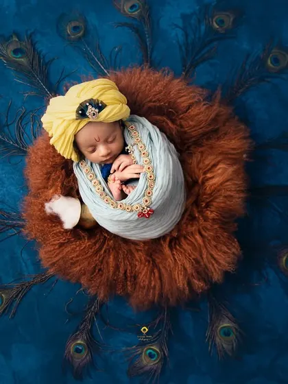 This portrait captures the divine innocence of a newborn. I used rich colors, soft textures, and an array of peacock feathers to create this unique Little Krishna setup, turning a photograph into a piece of art.