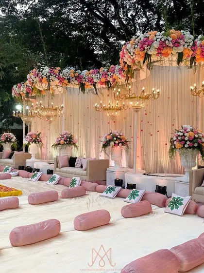 A view of the traditional floor seating for the Mamera ceremony, with comfortable pink bolsters and custom-printed cushions for guests.