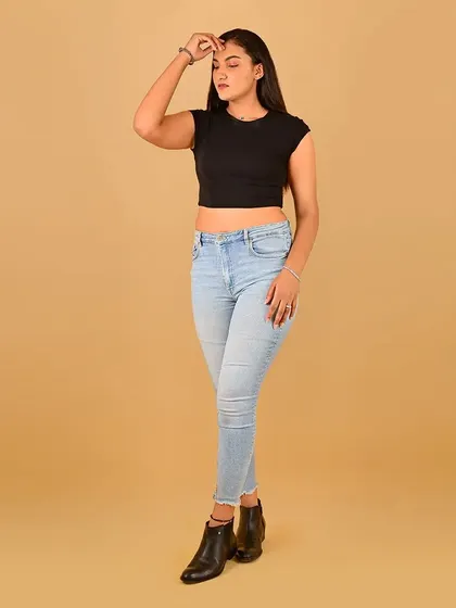 A full-body shot with a dynamic pose. The clean makeup ensures versatility for her portfolio.