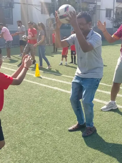 A father helps his son with a ball-handling exercise, a heartwarming moment from our Community Fest.