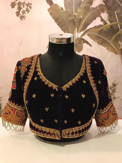 A luxurious royal purple velvet blouse with heavy zardosi and thread work embroidery. This is a perfect statement piece to pair with a silk saree for a wedding.
