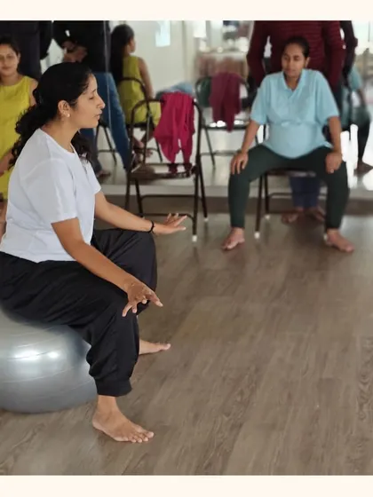An instructor demonstrates the use of a stability ball for labor preparation. These tools help mothers-to-be find comfortable positions and encourage gentle movement to facilitate the birthing process.