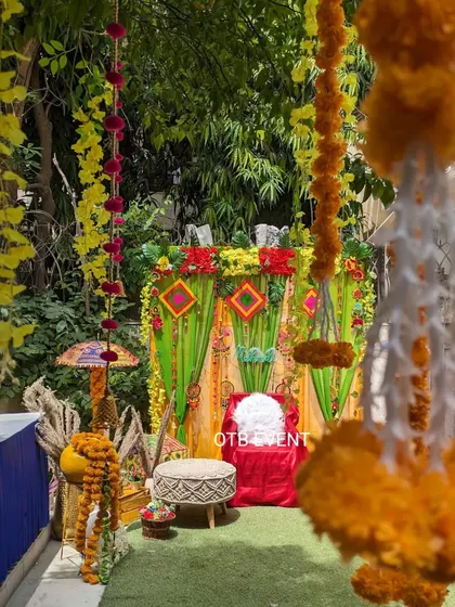 A view through hanging marigold garlands of the colorful Mehendi seating area. I love creating these layered looks that are perfect for photos.