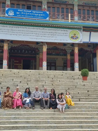 Our community group sitting on the steps of Sera Jey Monastic University. This photo captures the joy and gratitude of our members who traveled to witness this important milestone.