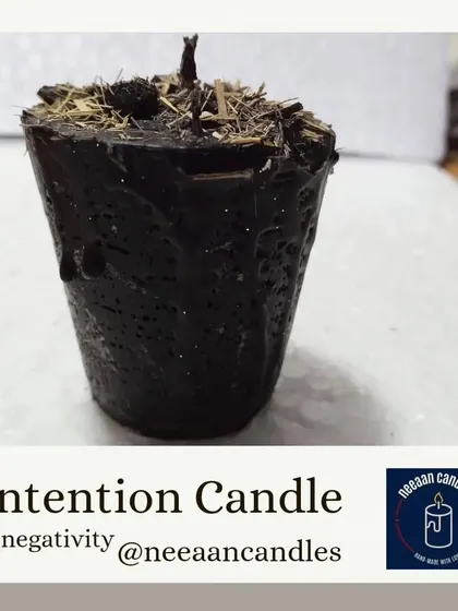 This is my intention candle for clearing negativity. I make it with special herbs and oils designed to absorb and transmute heavy vibrations, creating a sacred and peaceful space.