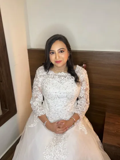 A seated portrait of Meghana, showing her subtle and sophisticated bridal makeup. We chose soft, neutral tones to enhance her natural beauty without overpowering her delicate look.