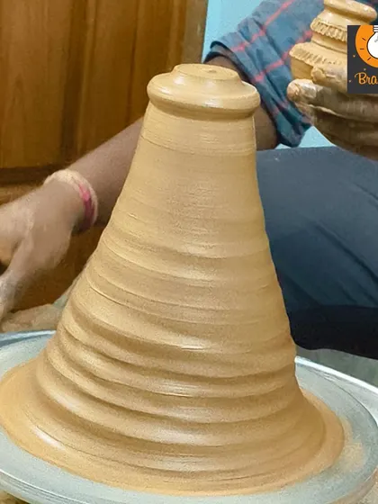 Our pottery instructor demonstrates how to shape the clay on the wheel, a magical process for kids to watch and learn.