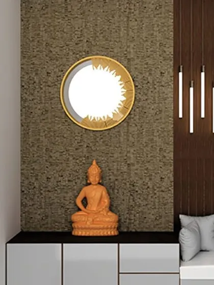 A modern foyer design with a Buddha statue, a stylish mirror, and a comfortable grey seating nook.
