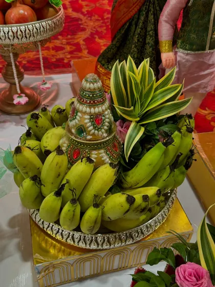 A platter of green bananas arranged around a decorated 'kalash'. This is a classic element in many traditional South Indian ceremonies, and I make sure it looks beautiful.