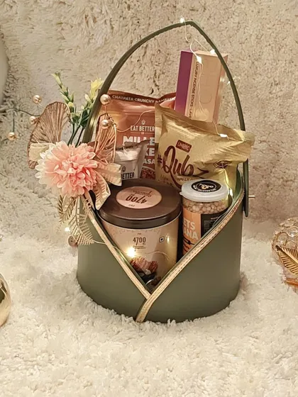 The luxury olive green basket, beautifully styled and ready to be gifted. The combination of gourmet snacks and elegant packaging makes it a standout choice for client appreciation.