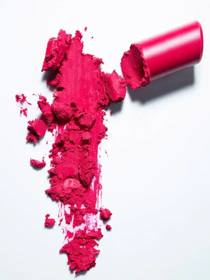 This top-down shot shows a smashed lipstick smear, creating a raw and artistic representation of the product's color and texture. It's a great way to create compelling beauty imagery that goes beyond a simple product photo.