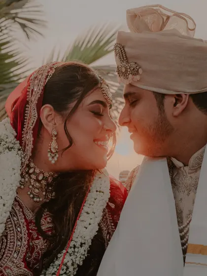 A beautiful, sun-kissed close-up of the couple, capturing their loving gaze after the ceremony.