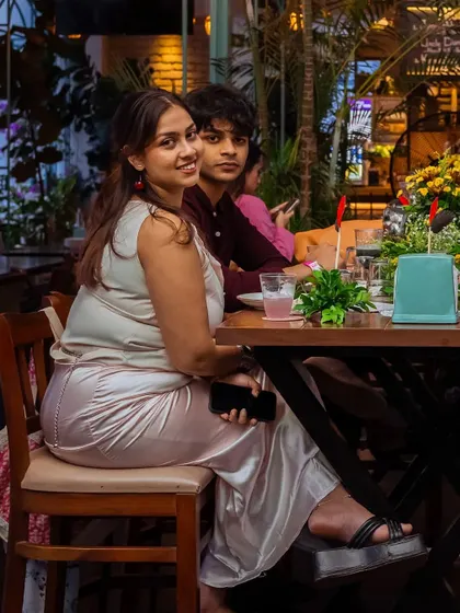 Guests seated at a table, enjoying the ambiance. The mix of seating styles allows for comfortable arrangements for groups of all sizes.
